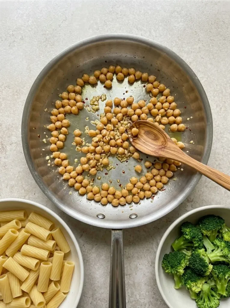 Broccoli Chickpea Pasta for a Quick Meatless Dinner Broccoli Chickpea Pasta Chickpeas sautéing with garlic and red pepper flakes in olive oil